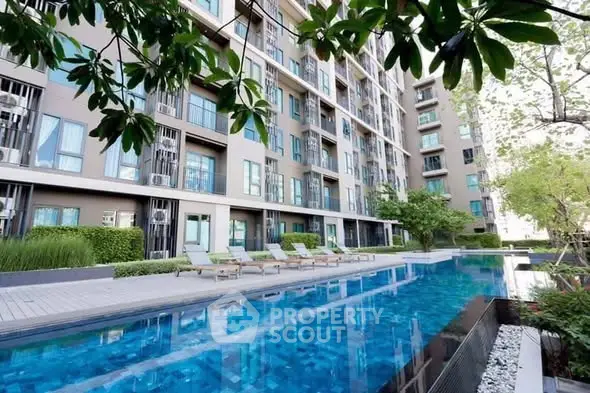 Modern apartment building with luxurious pool and lush greenery