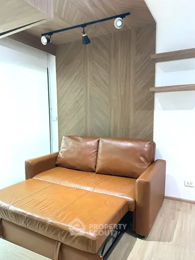 Modern living room with stylish brown leather sofa and wooden accent wall