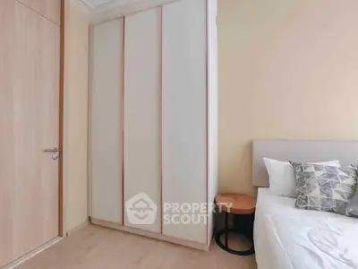 Modern bedroom with sleek wardrobe and cozy bed setup