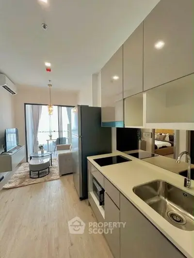 Modern open-layout kitchen and living room with sleek design and natural light