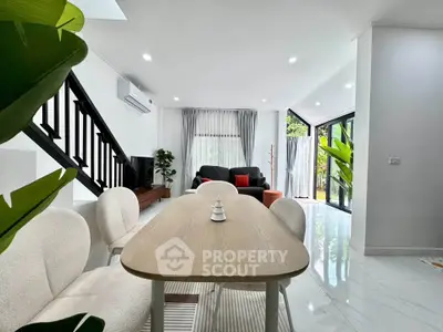 Modern open-plan living room with stylish furniture and large windows for natural light.