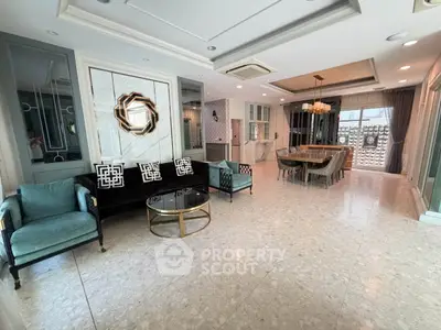 Luxurious open-plan living and dining area with elegant decor and ample natural light.