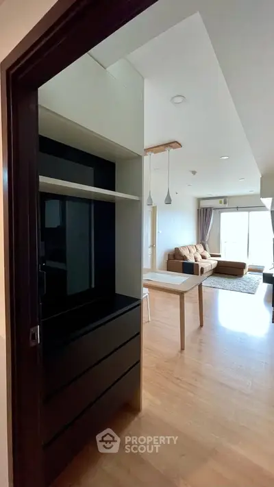 Spacious living room with modern furniture and open layout, perfect for entertaining guests.