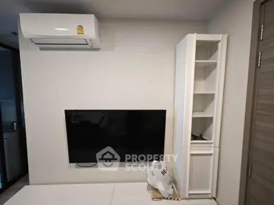 Modern living room with wall-mounted TV and air conditioning unit, showcasing sleek design and comfort.