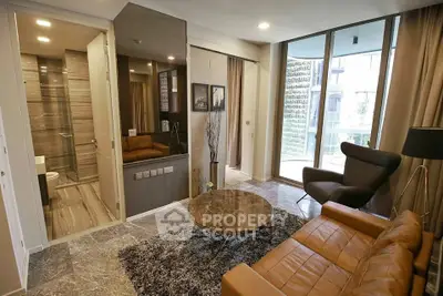 Modern living room with leather sofa and large windows offering natural light.
