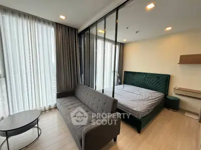 Modern bedroom with floor-to-ceiling windows and stylish furnishings