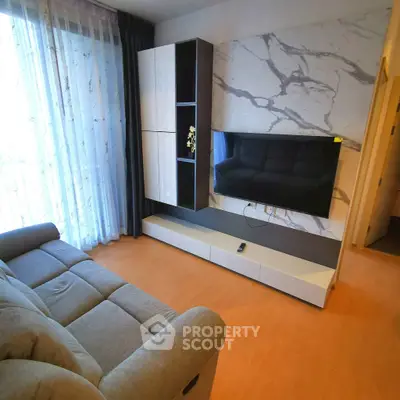 Modern living room with stylish TV setup and cozy sofa