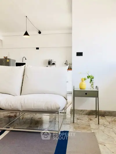 Modern living room with sleek white sofa and stylish decor