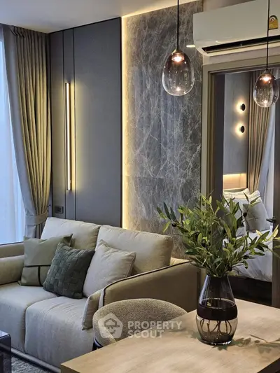 Modern living room with elegant decor, featuring a cozy sofa, stylish lighting, and a touch of greenery.