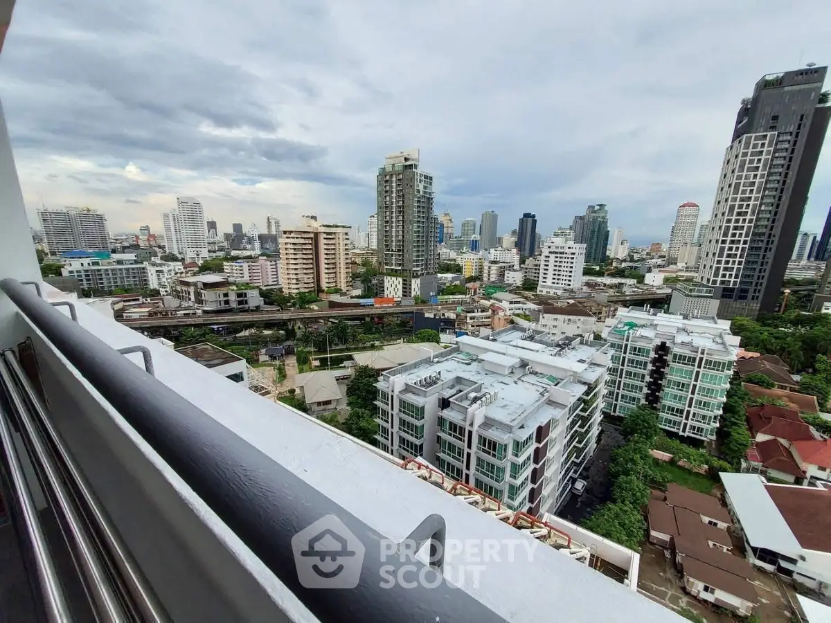 Stunning cityscape view from high-rise balcony overlooking urban skyline.
