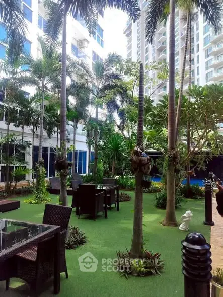 Luxurious garden area with outdoor seating in a modern residential complex.