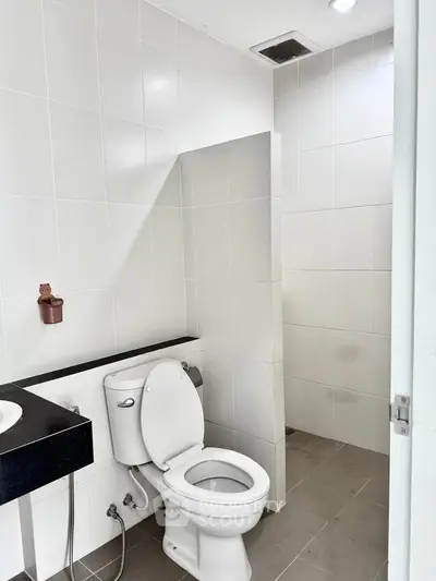 Modern bathroom with sleek white tiles and contemporary fixtures