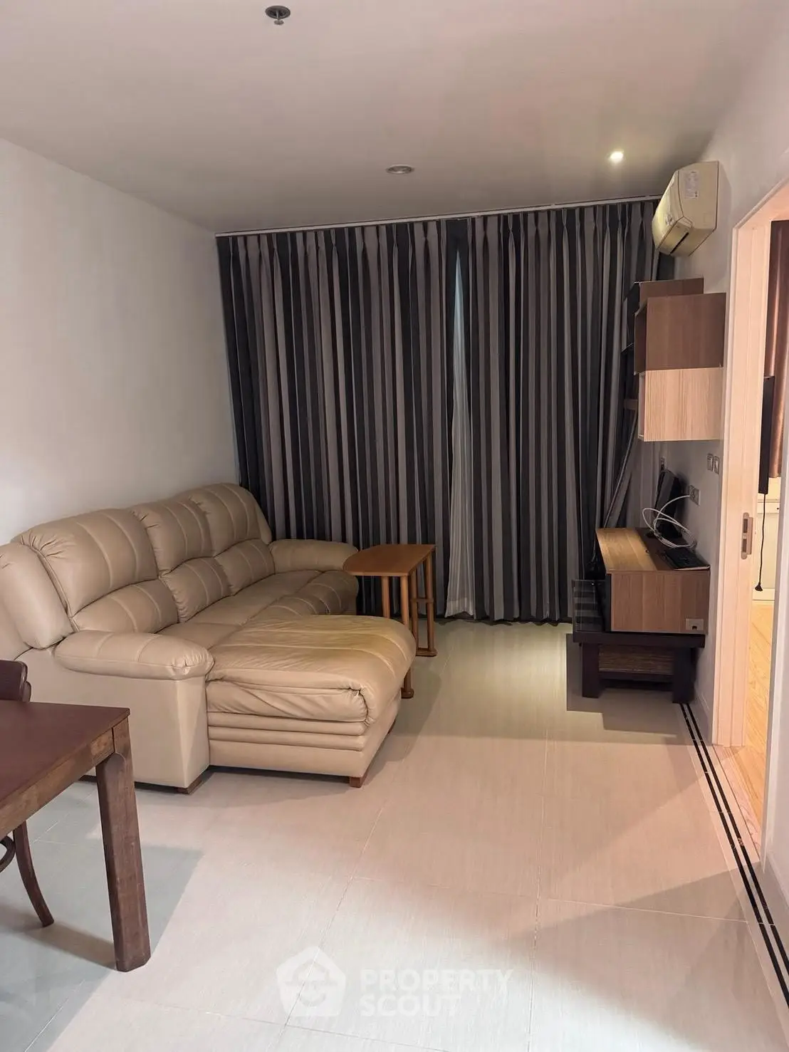 Cozy living room with leather sofa and modern entertainment unit