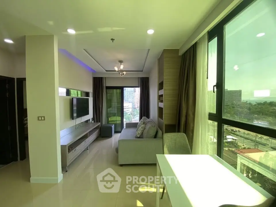 Modern living room with large windows and city view, featuring sleek furniture and natural light.