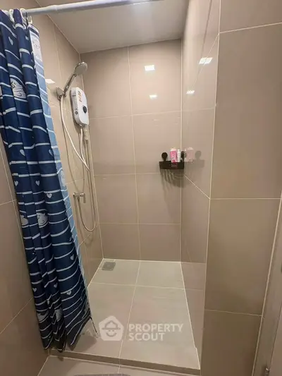 Modern bathroom shower area with sleek tiles and shower curtain