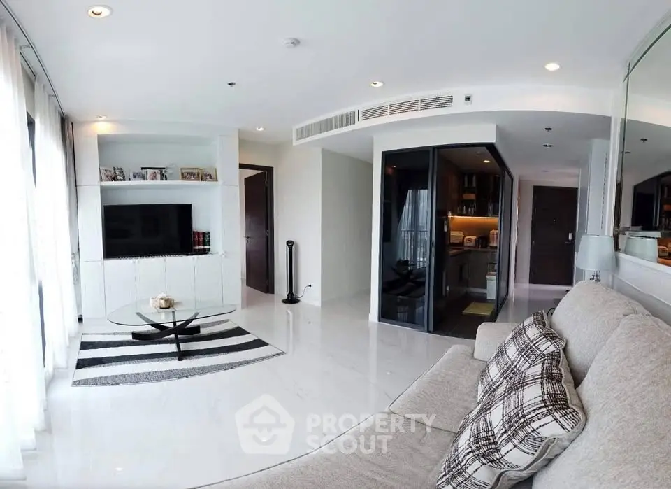 Spacious modern living room with elegant decor and open kitchen layout in luxury apartment.
