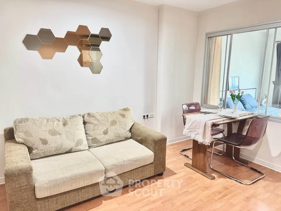 Charming living room with cozy sofa and dining area, perfect for modern living.
