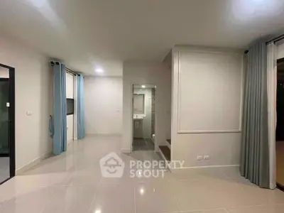 Spacious modern living room with elegant curtains and glossy tiled flooring