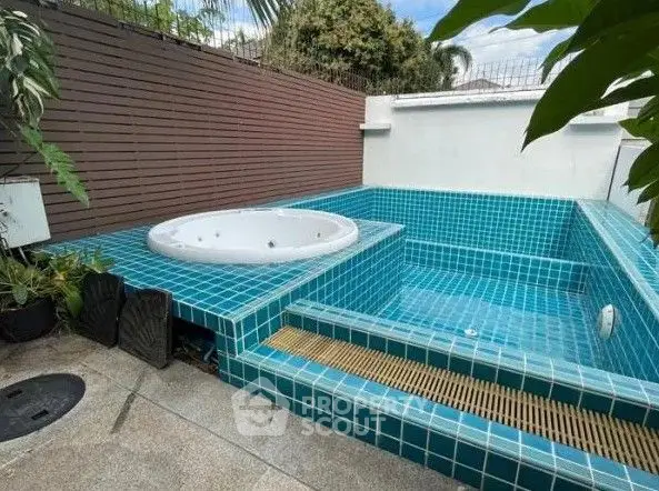 Luxurious outdoor pool and jacuzzi with modern tile design