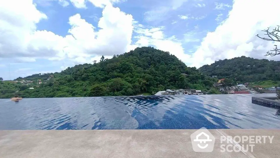 Stunning infinity pool with breathtaking mountain views in luxurious real estate setting.