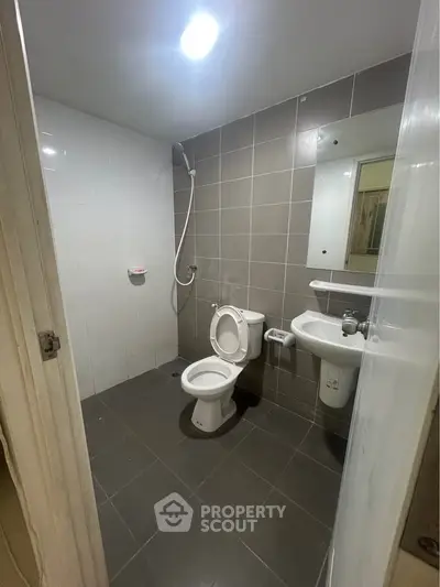 Modern bathroom with sleek gray tiles and contemporary fixtures.
