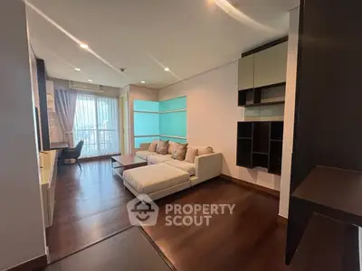 Spacious modern living room with elegant furniture and large windows offering natural light.