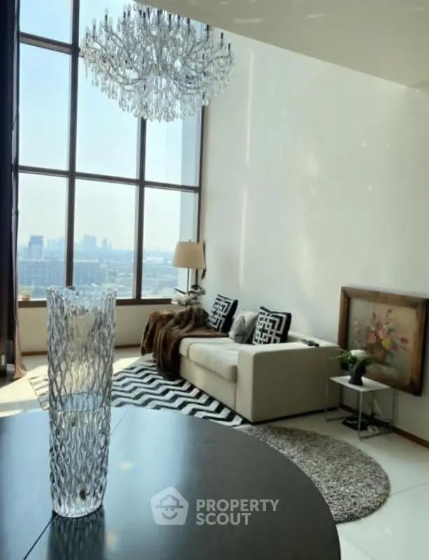 Luxurious living room with floor-to-ceiling windows and elegant chandelier