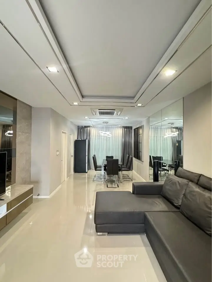 Modern living room with sleek design and spacious layout, featuring a stylish dining area and contemporary furniture.