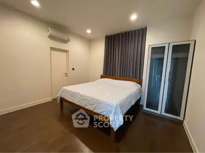 Spacious bedroom with modern decor and ample natural light