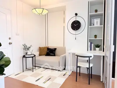 Modern living room with cozy sofa, stylish clock, and elegant decor in a bright apartment.