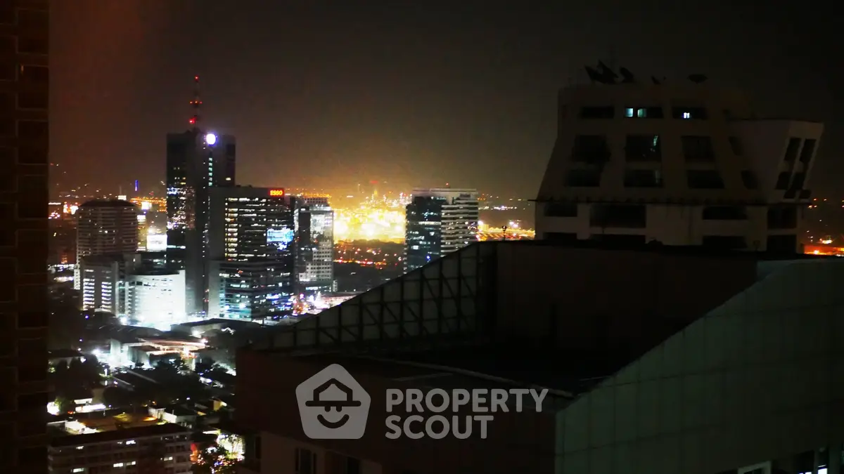 Stunning night cityscape view from a high-rise building, showcasing vibrant city lights.