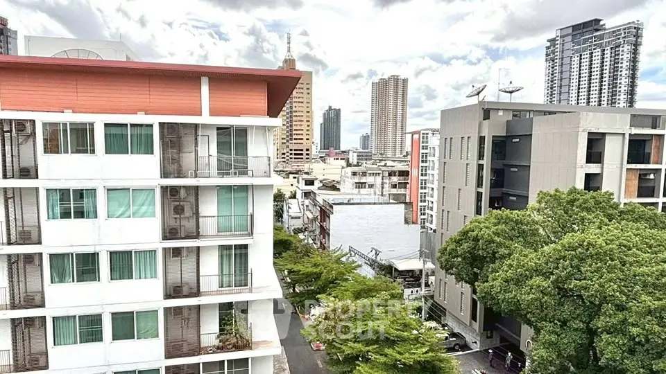 Stunning urban view showcasing modern high-rise buildings and lush greenery, perfect for city living.