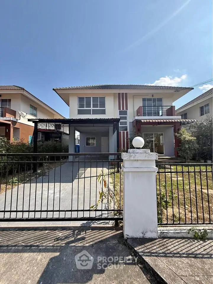 Charming two-story house with spacious driveway and front garden in a serene neighborhood.