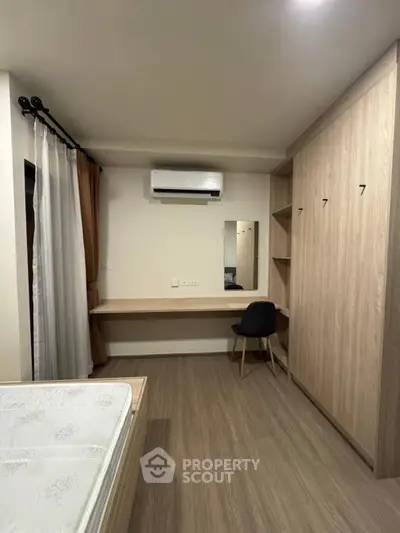 Modern bedroom with built-in wardrobe and air conditioning, perfect for comfort and style.