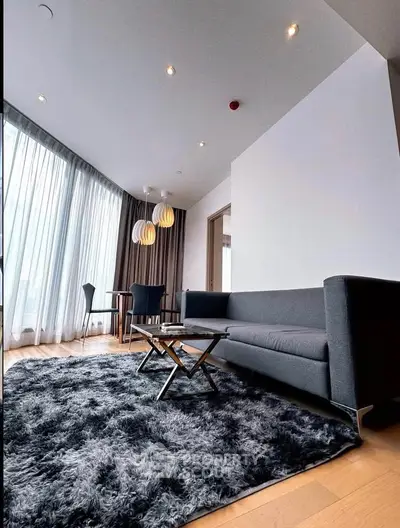 Modern living room with stylish furniture and large windows in a luxury apartment.