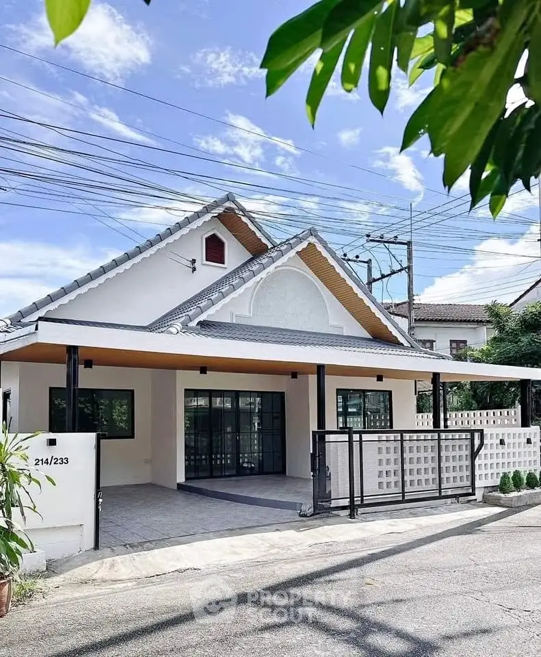 Charming modern house with spacious driveway and stylish roof design in a serene neighborhood.