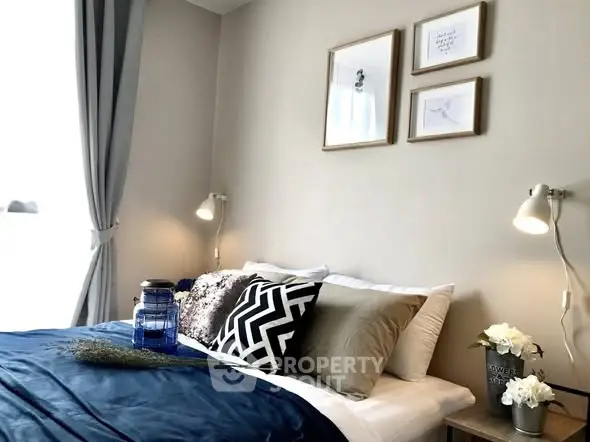 Cozy bedroom with stylish decor and natural light, perfect for relaxation.