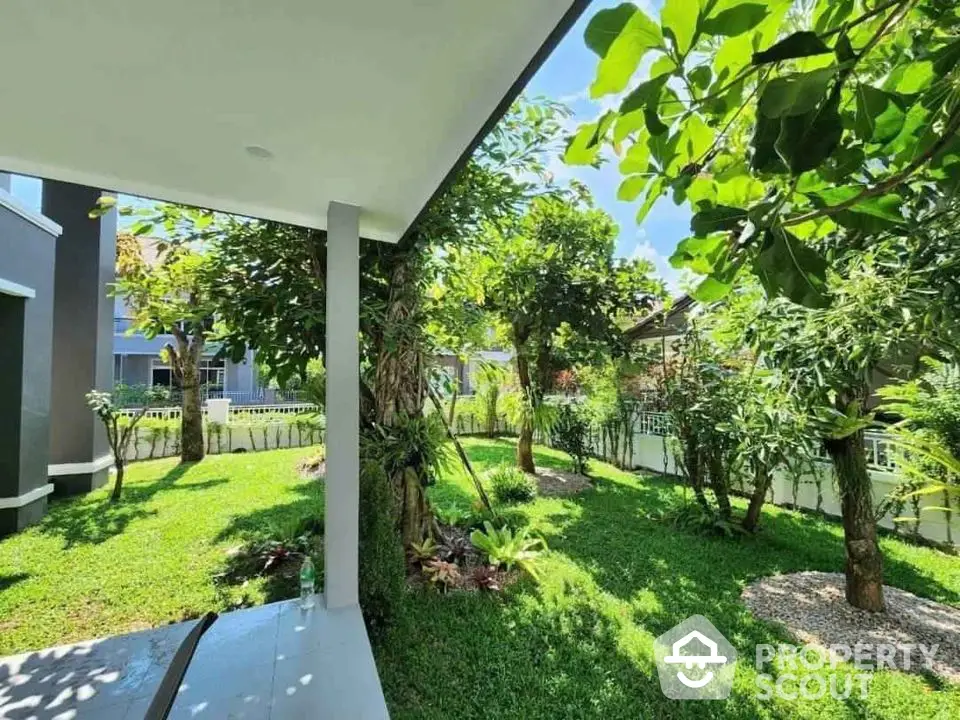 Beautiful garden view from a modern home patio, lush greenery and serene atmosphere.