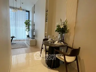 Modern dining area with elegant table setting and natural light in a stylish apartment.