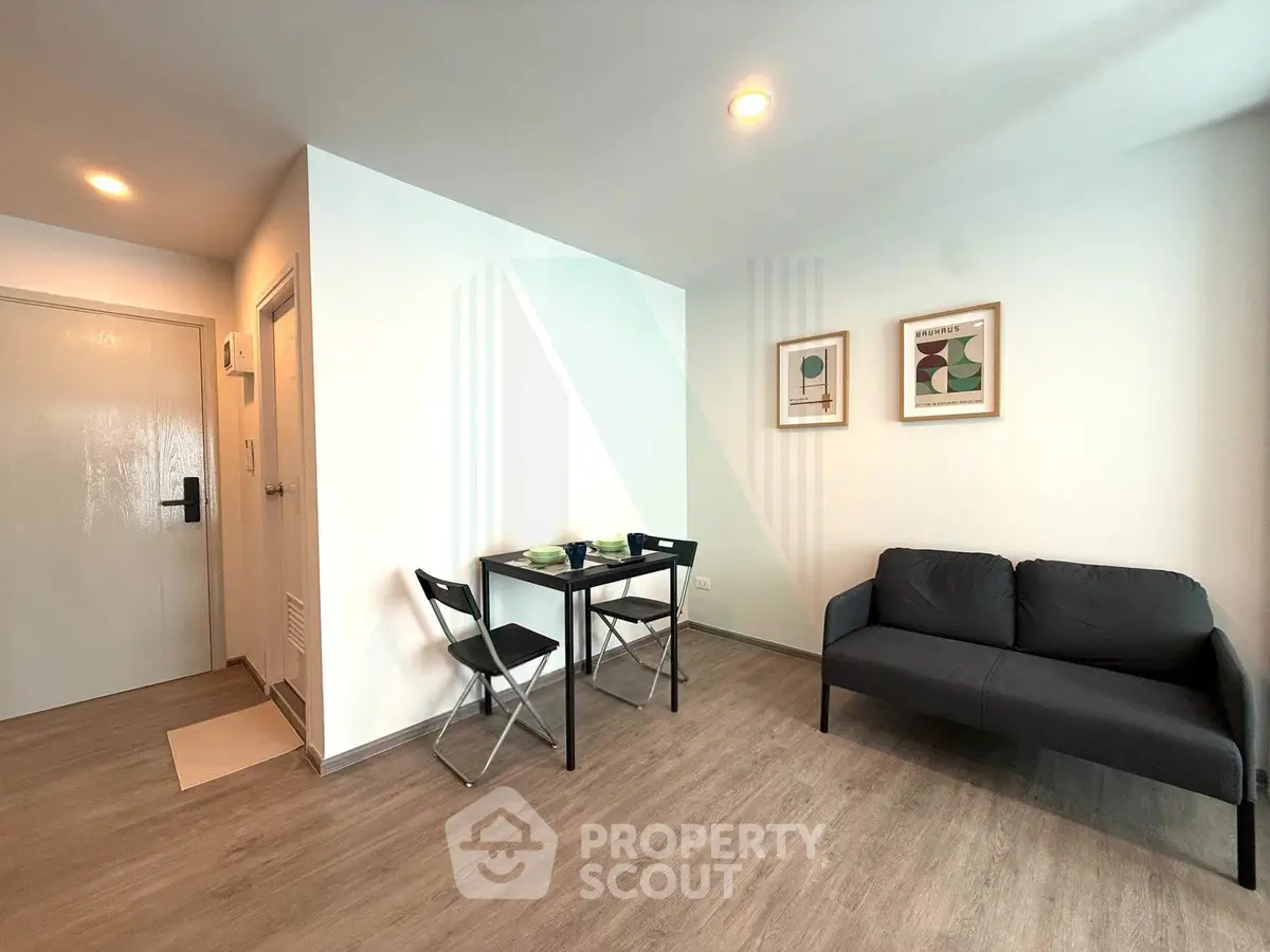 Modern living room with minimalist decor, featuring a cozy sofa and dining area, perfect for urban living.