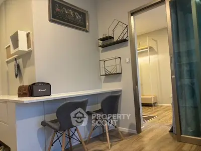Modern study area with stylish chairs and shelving in a contemporary apartment.