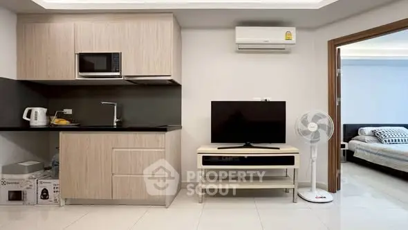 Modern studio apartment with compact kitchen and cozy living area