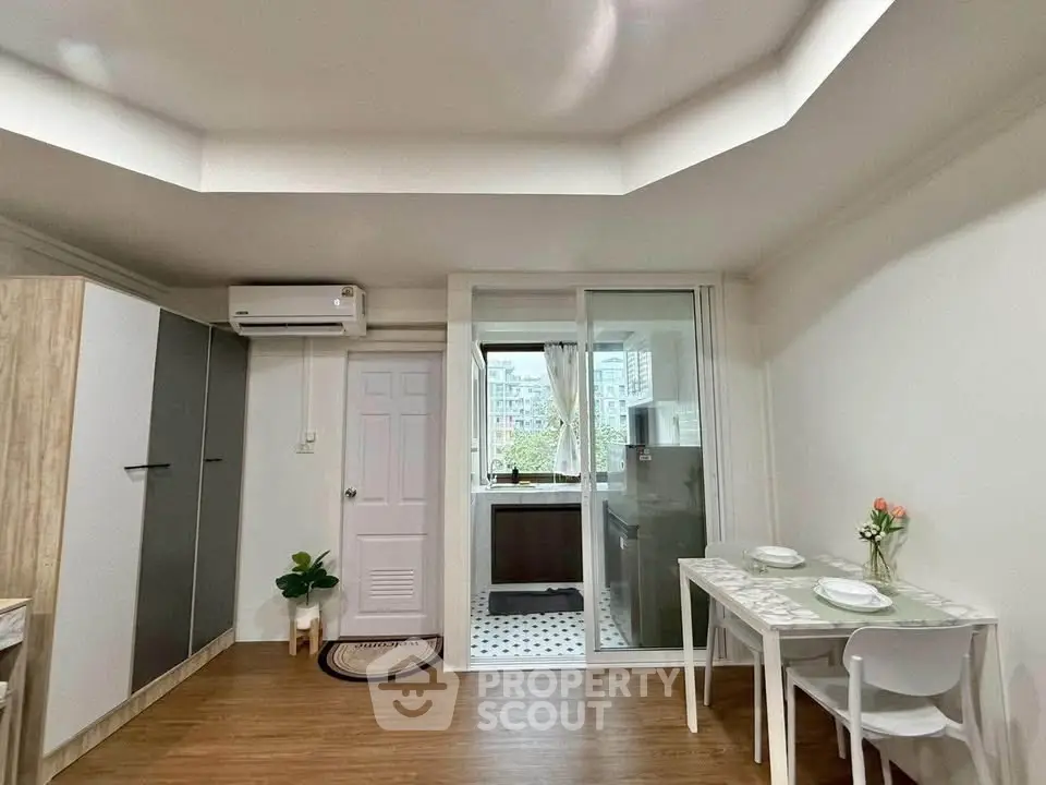 Modern apartment interior with dining area and balcony view