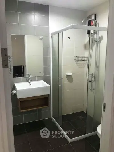 Modern bathroom with glass shower enclosure and sleek sink design