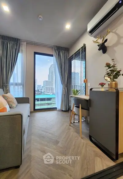 Modern living room with city view, stylish decor, and natural light.