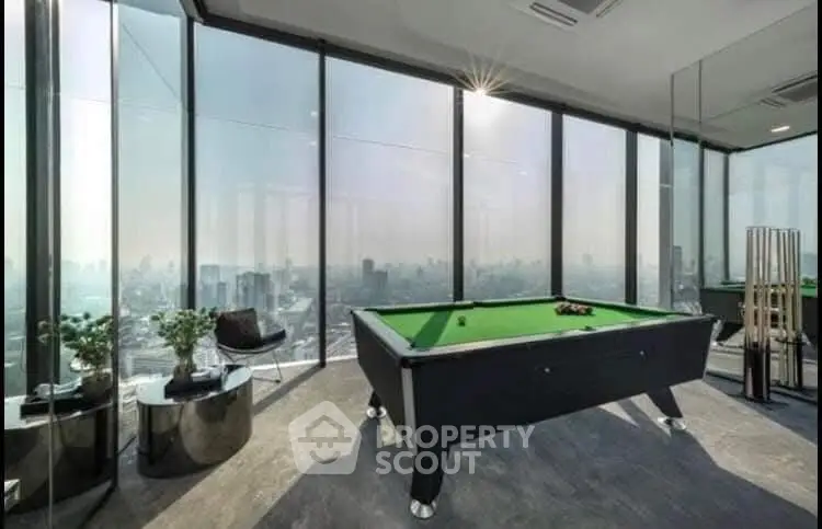 Luxurious high-rise apartment with stunning city view and pool table in modern living area.