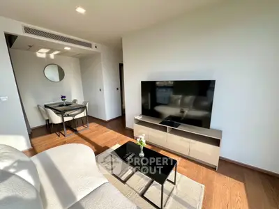 Modern living room with sleek TV setup and elegant dining area