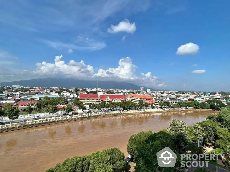 Stunning cityscape view with river and mountain backdrop, perfect for urban living enthusiasts.