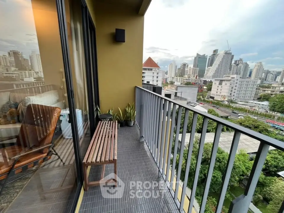 Spacious balcony with city skyline view, perfect for relaxation and enjoying urban living.