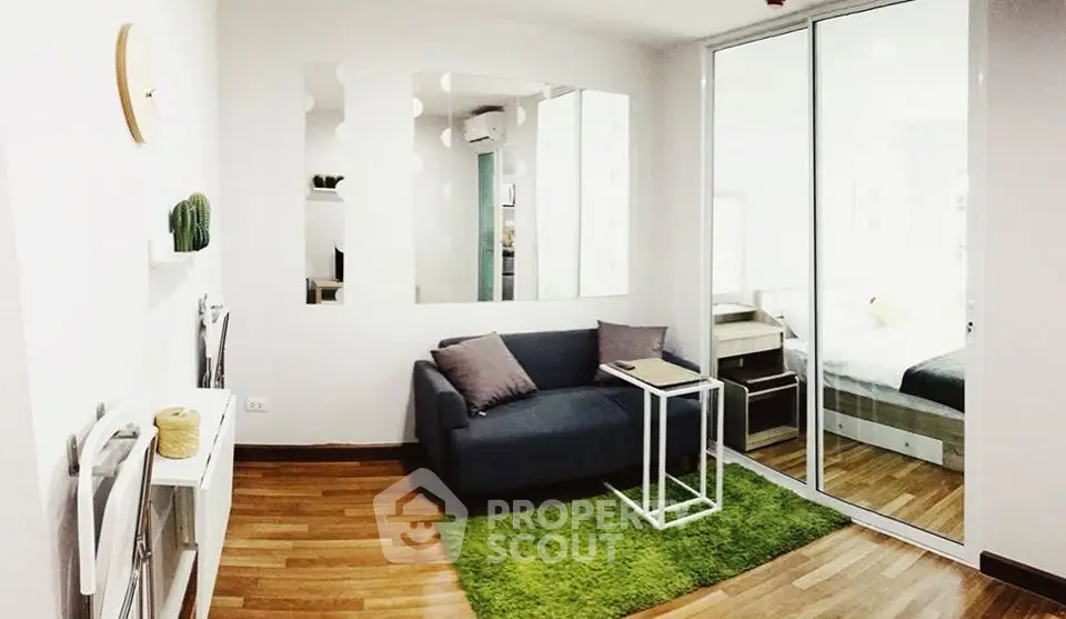 Modern living room with sleek design and cozy ambiance, featuring a stylish sofa and vibrant green rug.